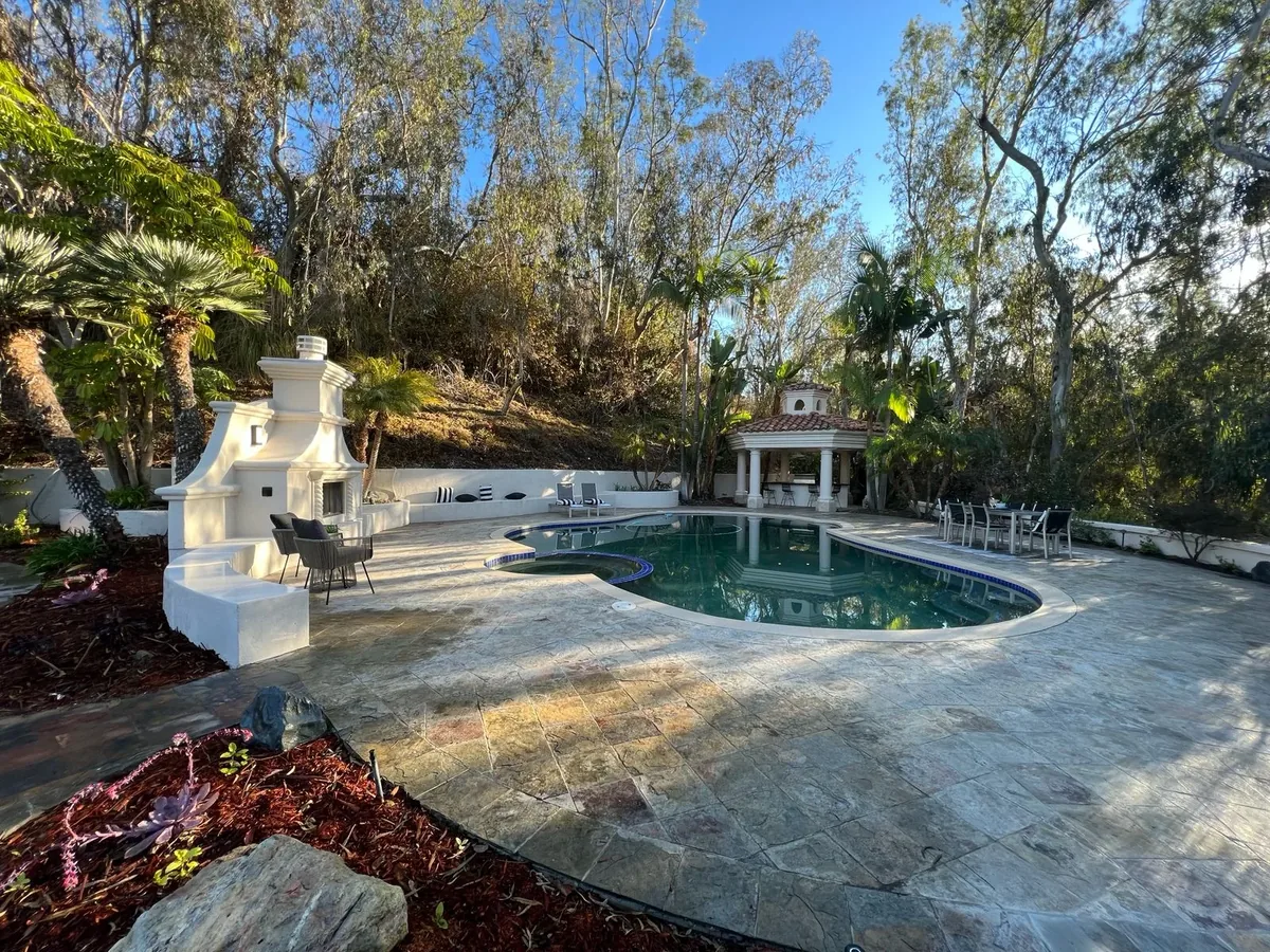 Modern backyard ADU project in San Diego with pool, outdoor fireplace and stamped concrete