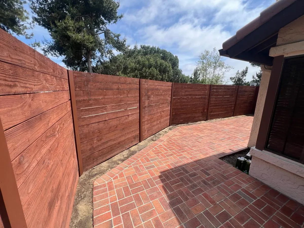 Stained horizontal wood privacy fence built as part of an outdoor project in San Diego