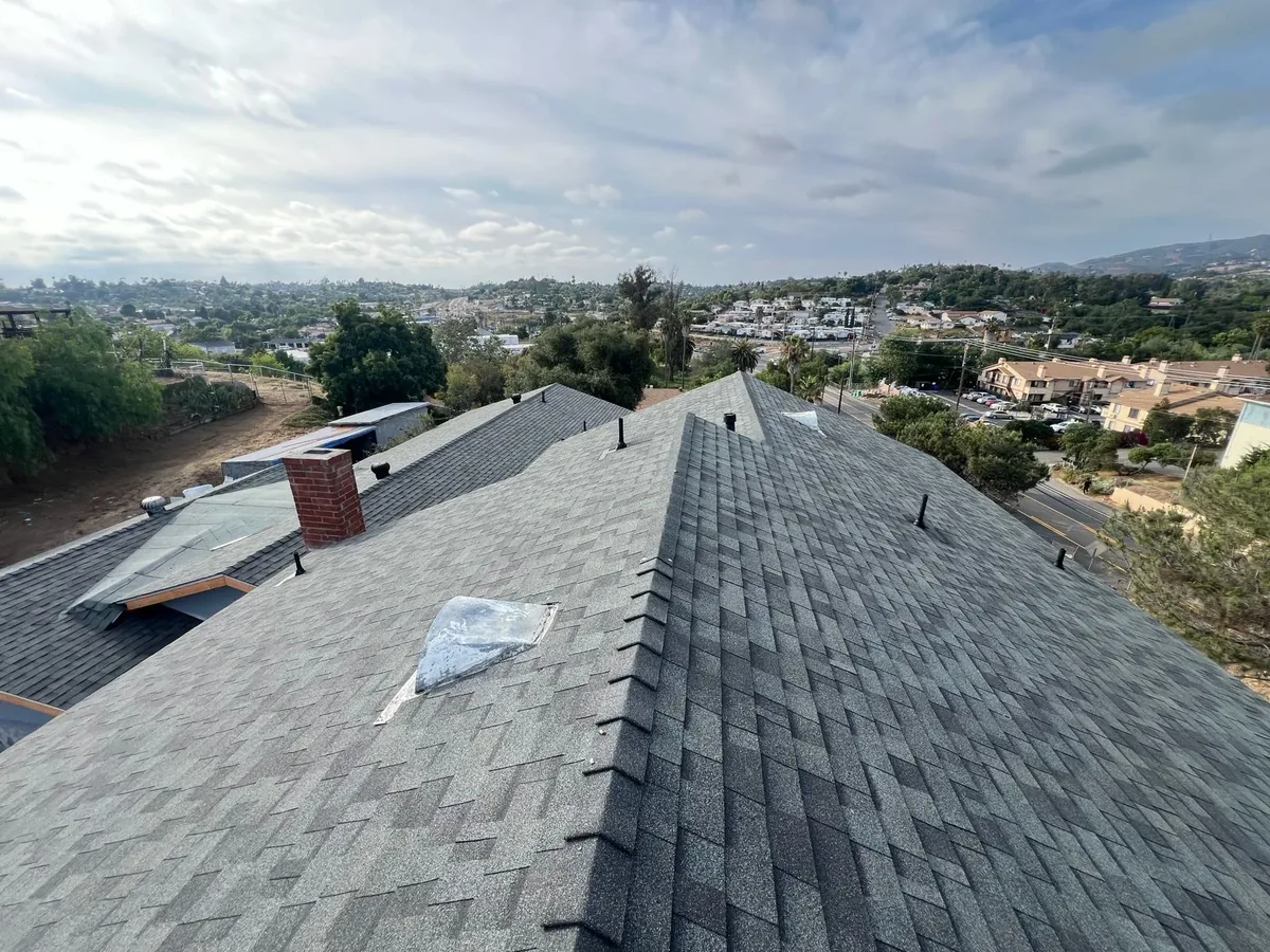 Newly shingled residential roof with gray architectural shingles overlooking a San Diego neighborhood
