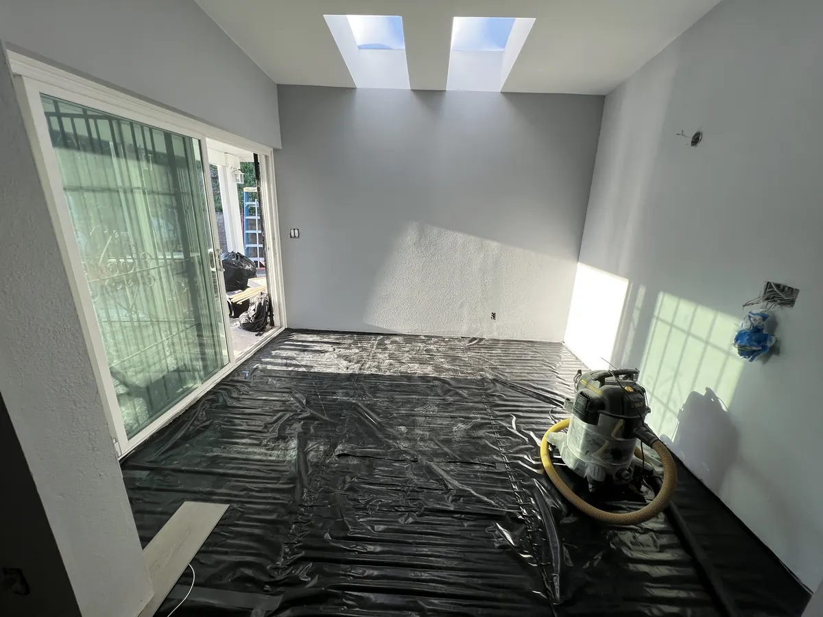 Black plastic sheeting laid over the concrete slab before the vinyl plank goes down