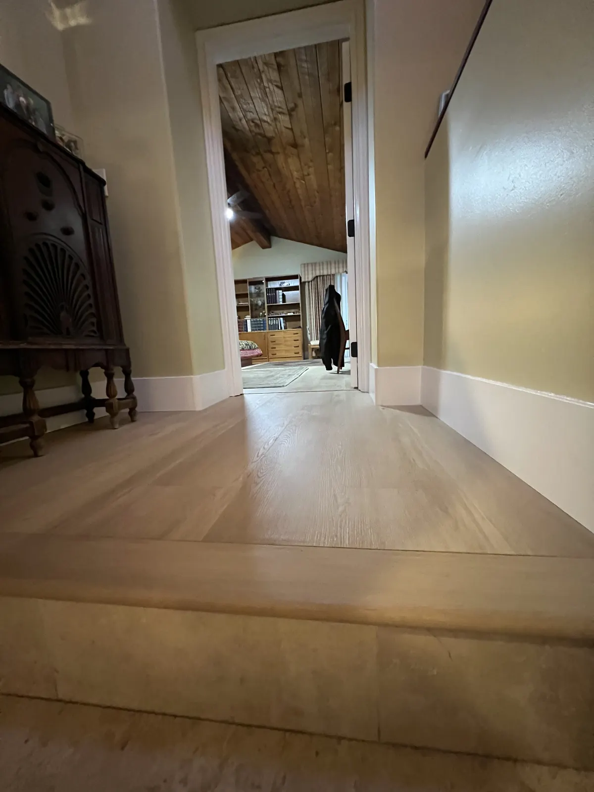 Upstairs landing with new light wood-look flooring running into the bedroom