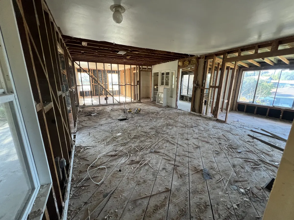 House interior gutted to the studs during a whole-house remodel, walls opened from end to end