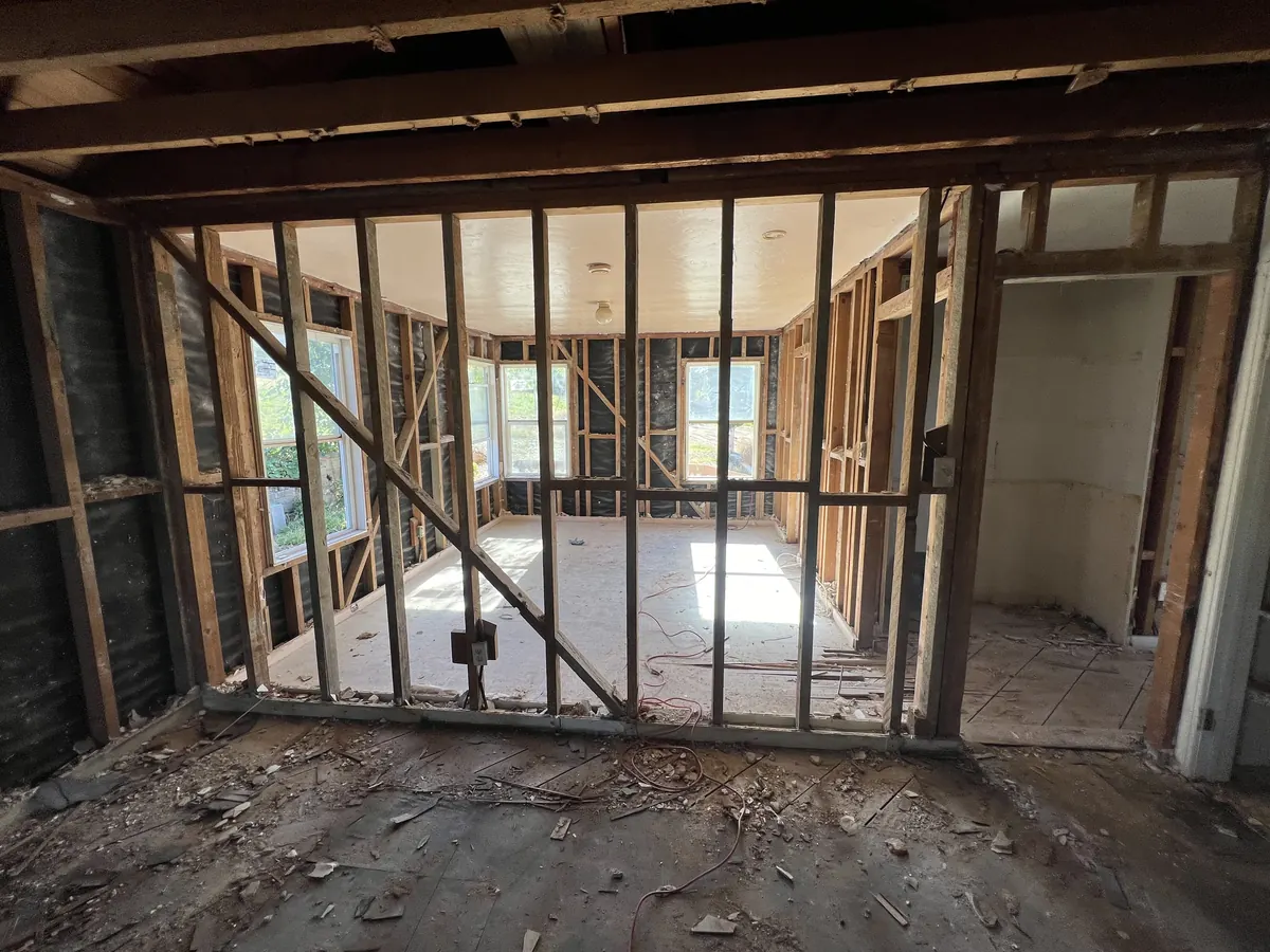 Old wall framing with a let-in diagonal brace, exposed during a whole-house remodel